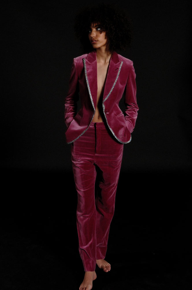
                  
                    Woman wearing custom tailored suit in hot pink velvet with piping 
                  
                