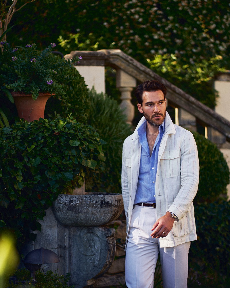 
                  
                    A young gentleman is standing in a stylish summer safari jacket
                  
                